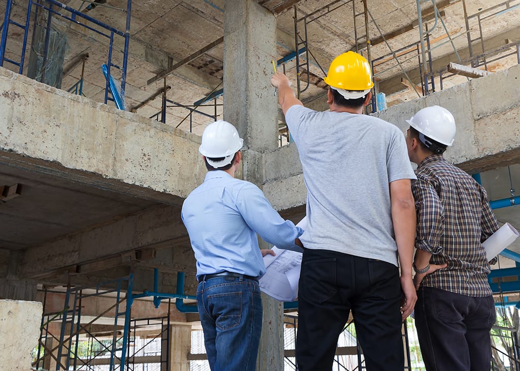 Illustrative photograph of professionals reviewing a construction site